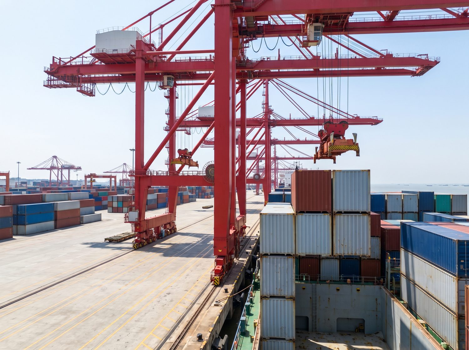 Shipping containers loaded onto a cargo vessel at a Chinese port